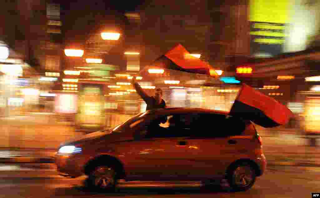 Supporters of the ruling VMRO DPMNE party celebrate their victory in local elections in Skopje, Macedonia.