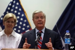 U.S. Senator Lindsey Graham right, speaks during a press conference at the Resolute Support headquarters in Kabul, Afghanistan, July 4, 2017. Senator Elizabeth Warren is shown at left.