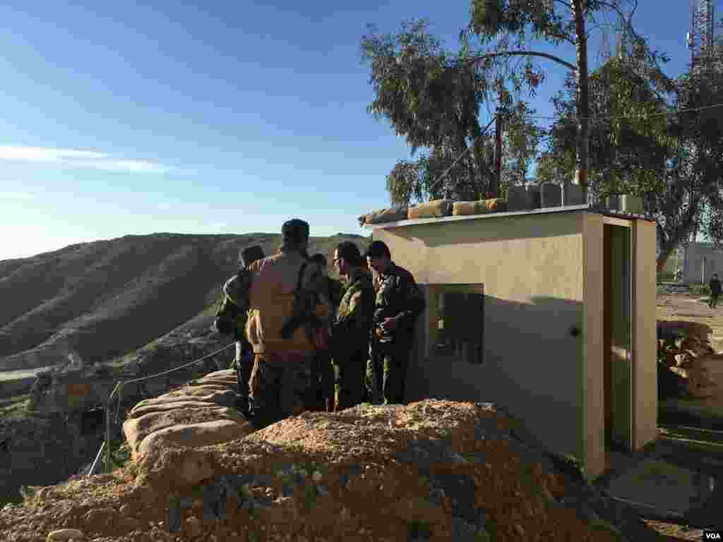 Iraqi Kurdish Peshmerga soldiers huddle around Maj. Gen. Sirwan Barzani in Makhmour, Iraq. Makhmour is expected to serve as one of the staging points for Iraqi and Peshmerga forces in the advance against the Islamic State-controlled city of Mosul, March 8