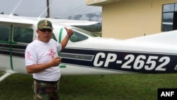 Counternarcotics police base in Mazamari, Peru, police Cmdr. Jaime Pizarro shows The Associated Press a Cessna 206 plane seized in April after it got stuck in sand on a clandestine airstrip, May 14, 2015.