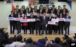 FILE - A group of lawmakers of the ruling Saenuri Party attends a press conference to announce to leave the party at the National Assembly in Seoul, South Korea, Dec. 27, 2016.