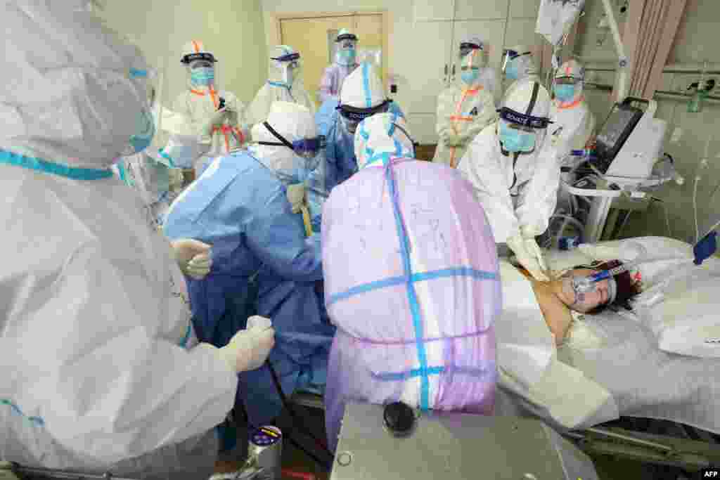 Medical staff treat a critical patient infected by the COVID-19 with an Extracorporeal membrane oxygenation (ECMO) at the Red Cross hospital in Wuhan in China&#39;s central Hubei province.