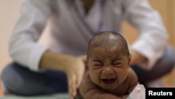 Pietro Rafael, who has microcephaly, reacts to stimulus during an evaluation session with a physiotherapist at the Altino Ventura rehabilitation center in Recife, Brazil, Jan. 28, 2016.