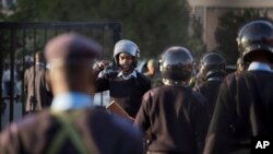 FILE - Riot police are ordered inside the Parliament building itself as chaos between MPs erupts inside, in Nairobi, Kenya, Dec. 18, 2014.