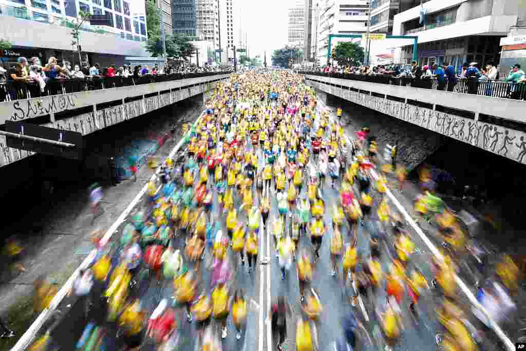 Runners compete in the Sao Silvestre international race in Sao Paulo, Brazil. The 15-kilometer race held annually on New Year&#39;s Eve, suspended in 2020 due to the coronavirus pandemic, was closed the public as a safety precaution but all runners were fully vaccinated.