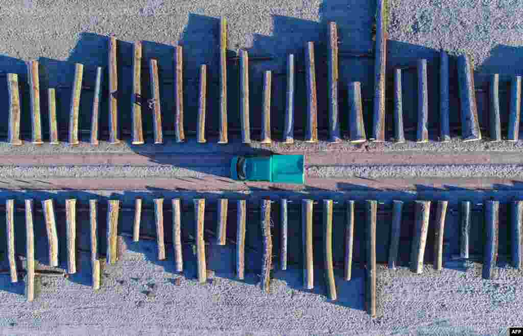 An aerial picture taken with a drone shows wood logs lined up at a storage facilities of a Brandebourg&#39;s forestry company in the eastern German town of Chorin.