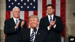 President Donald Trump, flanked by Vice President Mike Pence, left, and House Speaker Paul Ryan arrives on Capitol Hill in Washington for his address to a joint session of Congress, Feb. 28, 2017.