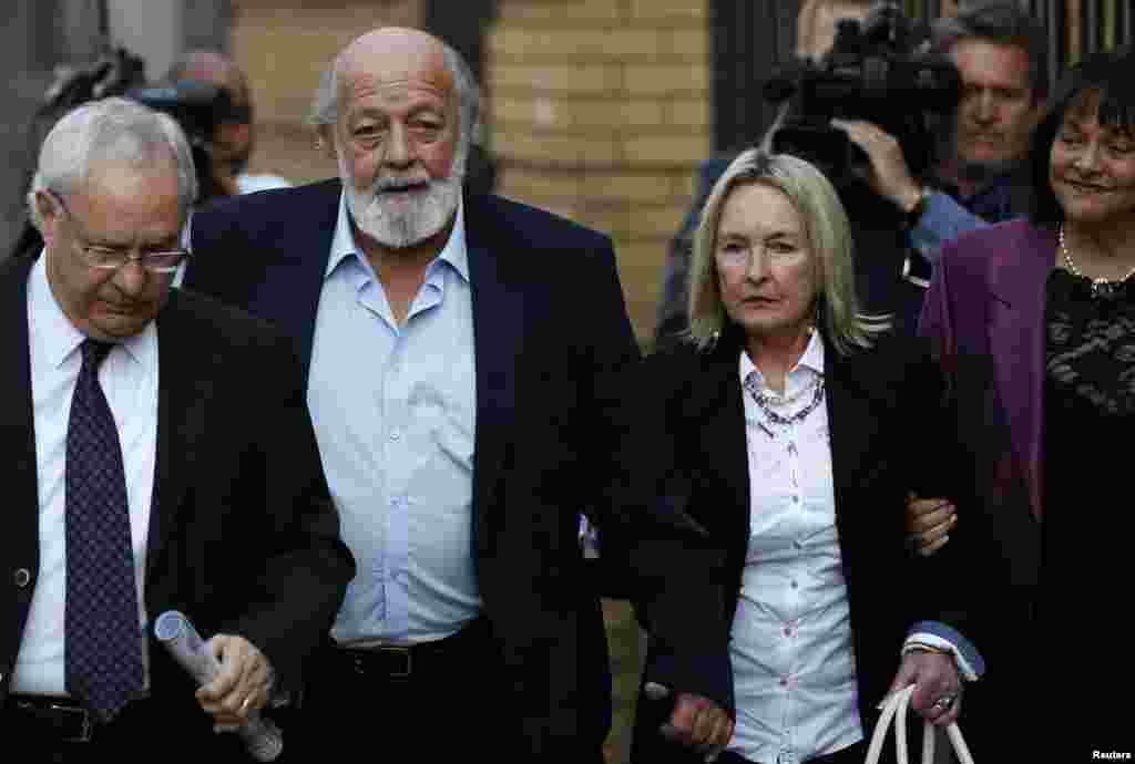 Reeva Steenkamp&#39;s parents, June (second from right) and Barry Steenkamp (second from left), arrive for the closing arguments in Oscar Pistorius&#39; murder trial, at the high court in Pretoria, Aug. 7, 2014.