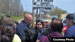 A Department of Homeland Security official speaks with the families of detainees outside the National Guard Armory. April 5, 2018, in Hamblen County, Tennessee. (Photo courtesy Morristown Citizen Tribune)