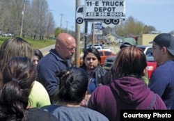 A Department of Homeland Security official speaks with the families of detainees outside the National Guard Armory. April 5, 2018, in Hamblen County, Tennessee. (Photo courtesy Morristown Citizen Tribune)