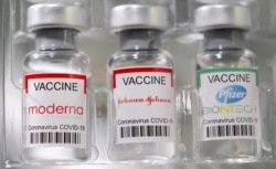 FILE PHOTO: Vials labelled "Moderna, Johnson & Johnson, Pfizer-BioNTech coronavirus disease (COVID-19) vaccine.