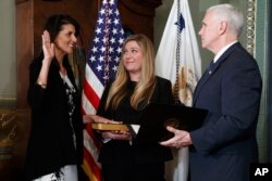 Vice President Mike Pence administers the oath of office to U.S. Ambassador to the UN, former South Carolina Gov. Nikki Haley, Jan. 25, 2017, in the Vice Presidential Ceremonial Office in the Eisenhower Executive Office building.