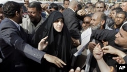 Maha al-Dori, a lawmaker loyal to anti-American Shiite cleric Muqtada al-Sadr, collects the demands of protesters during a protest at Tahrir Square in Baghdad, Iraq, February 23, 2011