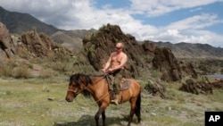 Putin is photographed riding a horse in the mountains of the Siberian Tyva region on August 3, 2009.