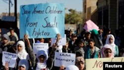 FILE - Children protest the Saudi-led coalition outside the U.N. offices in Sanaa, Yemen, Nov. 20, 2017. 