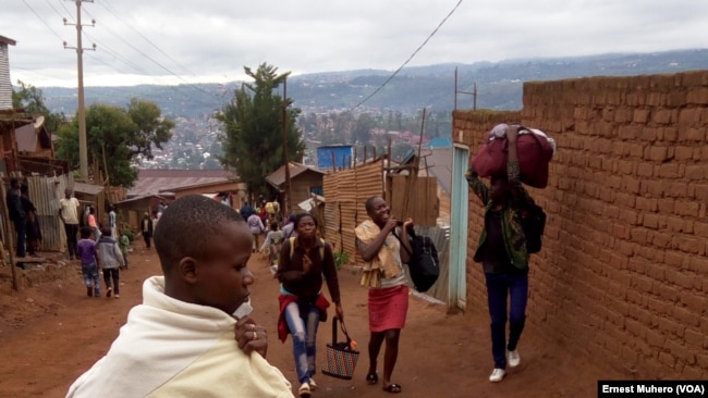 Certains dépendants des soldats habitant le camp Saio quittent le camp pour la cité, à Bukavu, RDC. (VOA/Ernest Muhero)