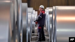 FILE - A worker controls steel coils at the Thyssenkrupp steel factory in Duisburg, Germany, Friday, April 27, 2018. Duisburg is the biggest steel producer site in Europe. (AP Photo/Martin Meissner)