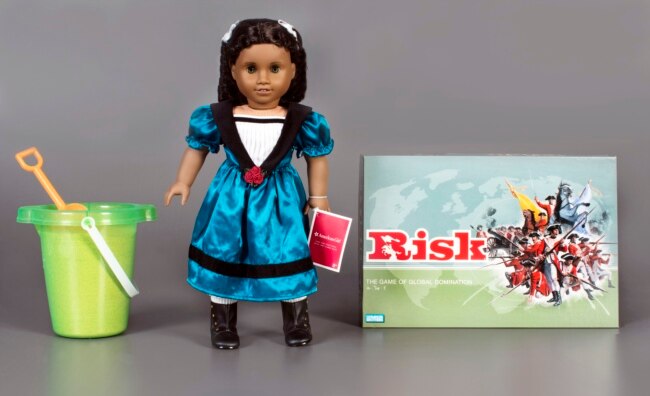 This photo, provided by The Strong National Museum of Play, shows the three toys being inducted this year into the National Toy Hall of Fame. They are, from left: sand, The American Girl Doll, and the game of Risk, that are being enshrined during a ceremony at the hall, located inside The Strong National Museum of Play, in Rochester, NY. (Strong National Museum of Play/Victoria Gray via AP)