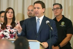 Florida Gov. Ron DeSantis answers questions related to school openings and the wearing of masks in Surfside, Fla. (AP Photo/Marta Lavandier)