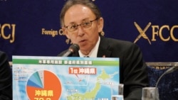 FILE - Okinawa Governor Denny Tamaki shows a chart on the U.S. military area in each prefecture in Japan during a press conference on March 1, 2019, in Tokyo.