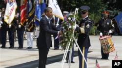 President Barack Obama places a wreath at the Tomb of the Unknowns during a Memorial Day ceremony at Arlington National Cemetery, May 30, 2011