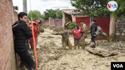 Fuerzas de seguridad ayudan a una persona a escapar de peligrosas inundaciones causadas por intensas lluvias en Tiquipaya, Cochabamba, Bolivia. Febrero 22 de 2020. Foto: Wilfford Miranda.