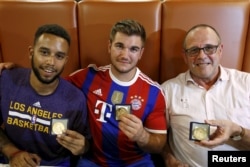 Anthony Sadler, from Pittsburg, California, Aleck Sharlatos from Roseburg, Oregon, and Chris Norman, a British man living in France (L-R), three men who helped to disarm an attacker on a train from Amsterdam to France, pose with medals they received for t