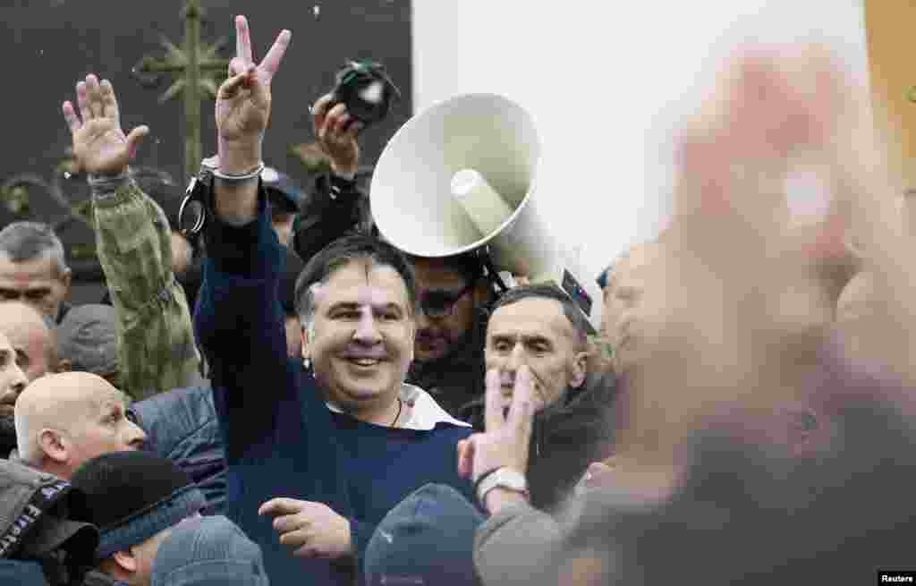 Georgian former President Mikheil Saakashvili flashes a victory sign after he was freed by his supporters in Kyiv, Ukraine.