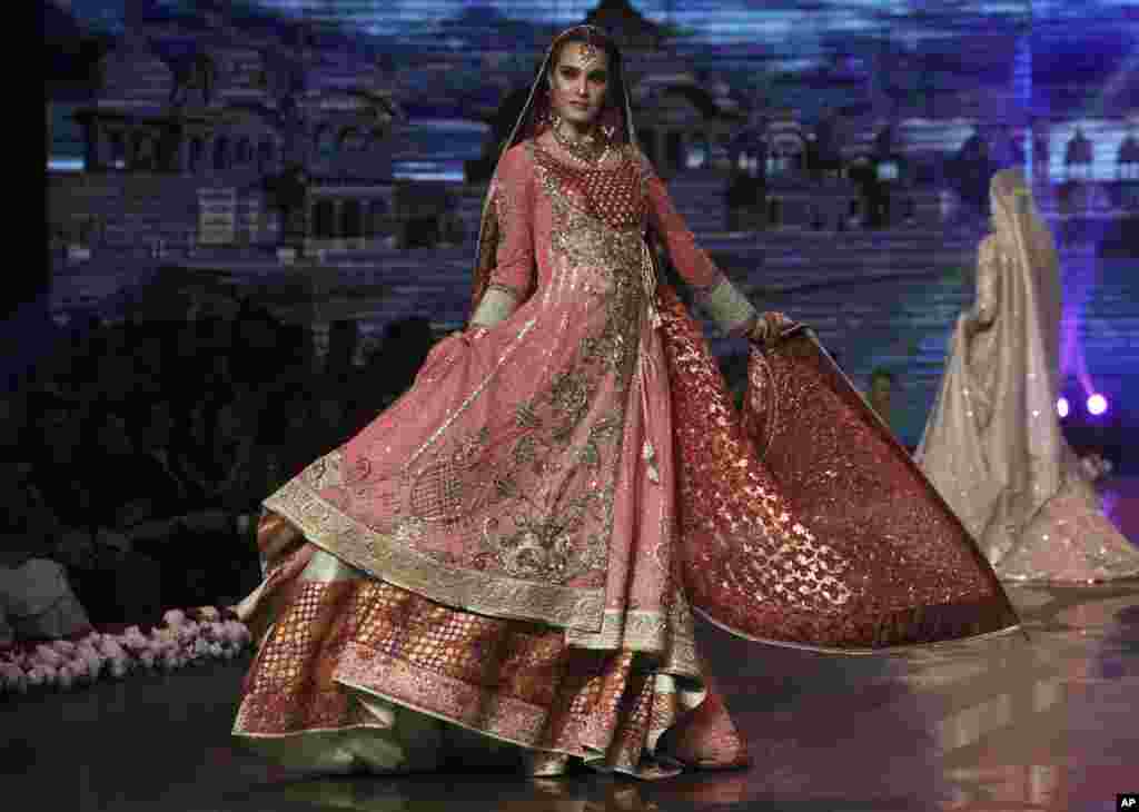 A model presents a bridal creation by designer Wardha Saleem during Bridal Couture Week 2016 in Lahore, Pakistan.