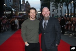 Actor Mark Wahlberg, left, arrives with oil rig manager Mike Williams, right, at the premiere of the film 'Deepwater Horizon' in London. The movie opens in theaters Friday.