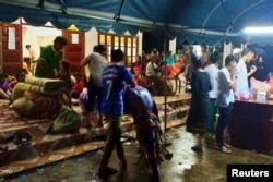 Villagers are seen inside a temporary shelter with their belonging as they evacuate after the Xepian-Xe Nam Noy hydropower dam collapsed in Attapeu province, Laos, July 24, 2018.