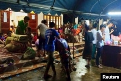 Villagers are seen inside a temporary shelter with their belongings as they evacuate after the Xe-Pian Xe-Namnoy hydropower dam collapsed in Attapeu province, Laos, July 24, 2018.