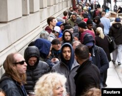 People wait in line for the opening of the Quebec Cannabis Society (SQDC) store, on the day Canada legalizes recreational marijuana, in Montreal, Quebec, Canada, Oct. 17, 2018.