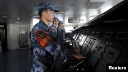 FILE - Chinese naval soldiers are pictured manning their stations on China's first aircraft carrier Liaoning, Nov. 30, 2013.