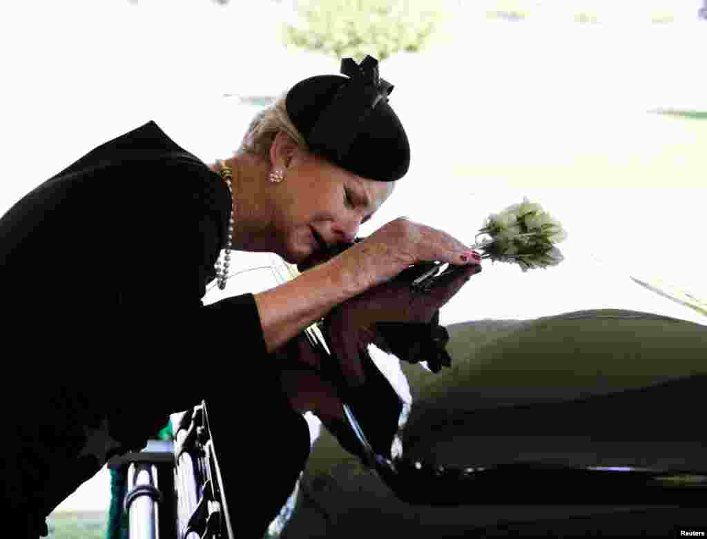 Cindy McCain lays her head on the casket of her late husband Sen. John McCain, R-Ariz., during a burial service at the cemetery at the United States Naval Academy in Annapolis, Maryland, Sept. 2, 2018.