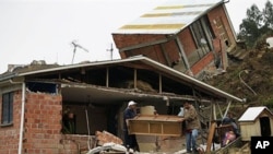 People recover belongings after a landslide, triggered by heavy rains, destroyed around 100 houses at the Valle de Flores neighborhood in La Paz, Bolivia, February 27, 2011