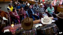 Residents listen to indigenous authorities acting as judges during a hearing related to a territorial limit conflict in their community, at the Indigenous City Hall in the Indian town of Solola, Guatemala, Jan. 16, 2017.