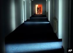 Romanian military staff stand at the end of a corridor on the Mihail Kogalniceanu airbase, near the Black Sea port of Constanta, a Soviet-era facility which became a key focus of a European investigation into allegations that the CIA operated secret prisons where torture took place.