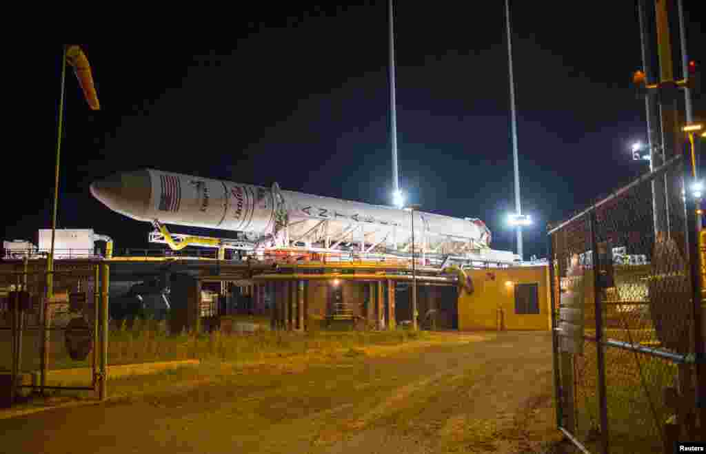 In this Oct. 24, 2014 handout photo provided by NASA, the Orbital Sciences Corporation Antares rocket, with the Cygnus spacecraft onboard, arrives at launch Pad-0A at NASA Wallops Flight Facility in Virginia. 