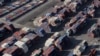 FILE - Shipping containers sit on the dock at a container terminal at the Port of Long Beach-Port of Los Angeles complex, in Los Angeles, California, April 7, 2021.