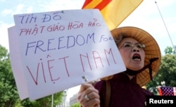 A Vietnamese-American woman protests outside the White House before President Donald Trump's meeting with Vietnamese Prime Minister Nguyen Xuan Phuc at the White House in Washington, May 31, 2017.