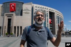 FILE - Erol Onderoglu, a journalist and Reporters Without Borders Turkey representative, talks outside a court in Istanbul, Turkey, July 16, 2020.