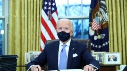 U.S. President Joe Biden signs executive orders in the Oval Office of the White House in Washington, after his inauguration as the 46th President of the United States, U.S., January 20, 2021.