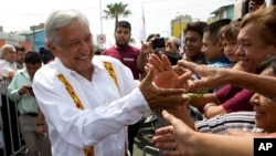 Presidential hopeful and two-time candidate Andres Manuel Lopez Obrador greets supporters as he arrives at a campaign rally for Delfina Gomez, who is running for Mexico state governor with his National Regeneration Movement, or MORENA, in Nezahualcoyotl, Mexico state, May 28, 2017.