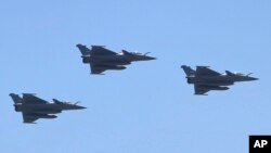 FILE - Three French made Rafale fighter jets fly in formation above Cairo, July 21, 2015.