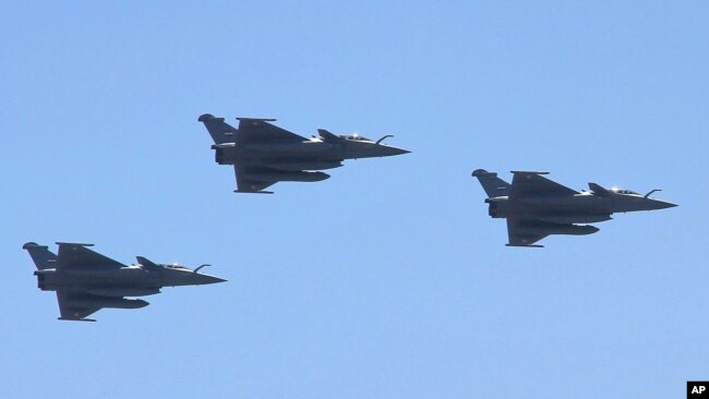FILE - Three French made Rafale fighter jets fly in formation above Cairo, July 21, 2015.
