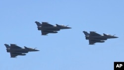 FILE - Three French-made Rafale fighter jets fly in formation above Cairo, July 21, 2015. 