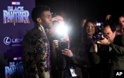 "Black Panther" actor Chadwick Boseman is surrounded by photographers as he poses at the premiere of the film at The Dolby Theatre on Monday, Jan. 29, 2018, in Los Angeles. (Photo by Chris Pizzello/Invision/AP)