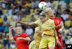 Germany's Alexandra Popp, right, and Sweden's Lisa Dahlkvist go for a header during the final of the women's Olympic tournament won by Germany, Aug. 19, 2016.