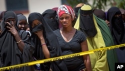 Members of the public gather outside the hospital mortuary, waiting to view the bodies of the alleged attackers, in Garissa, April 4, 2015. 